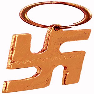 A Swastik locket made in brass on a white background